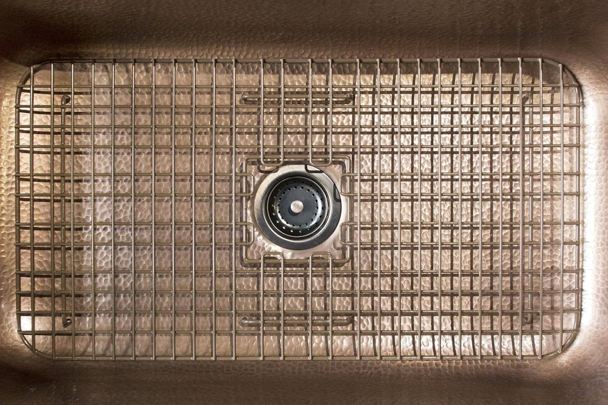Antique brown sink bottom grid with circular drain opening and wire mesh cover