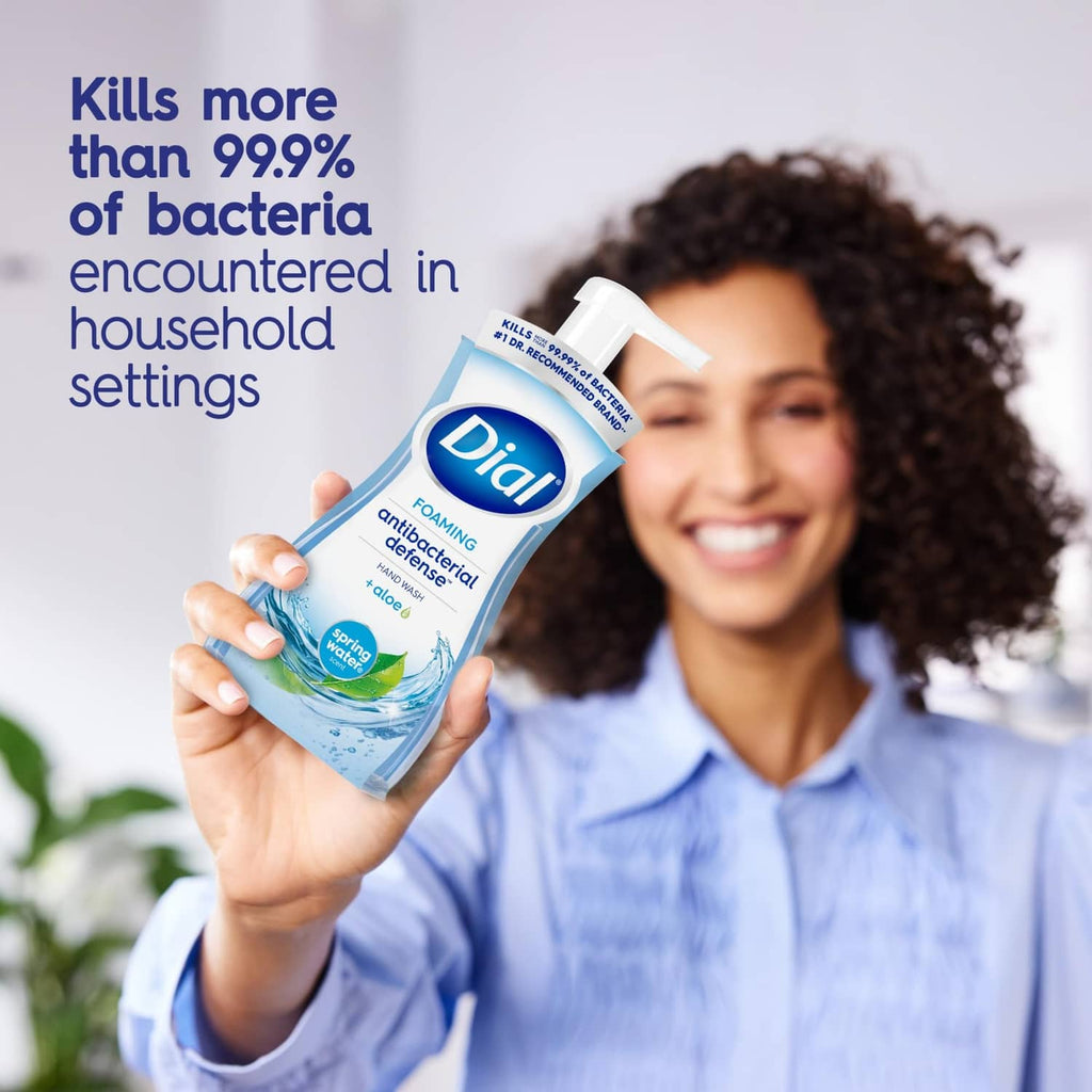 Dial antibacterial foaming hand soap bottle held by smiling woman