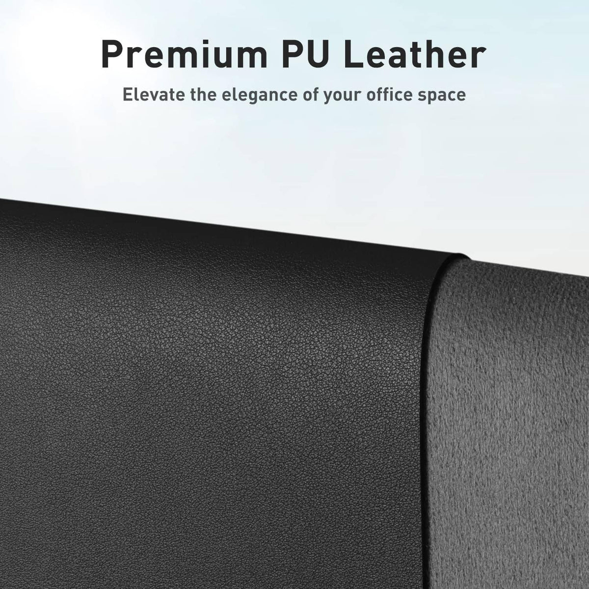 Close-up of black textured PU leather desk pad surface and curved edge