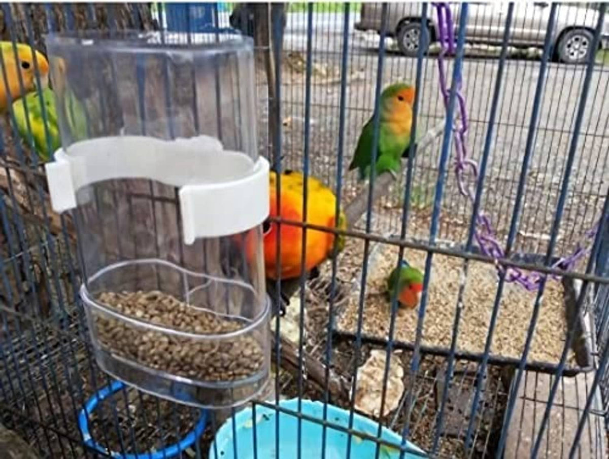 Clear automatic bird waterer with white holder attached to cage bars