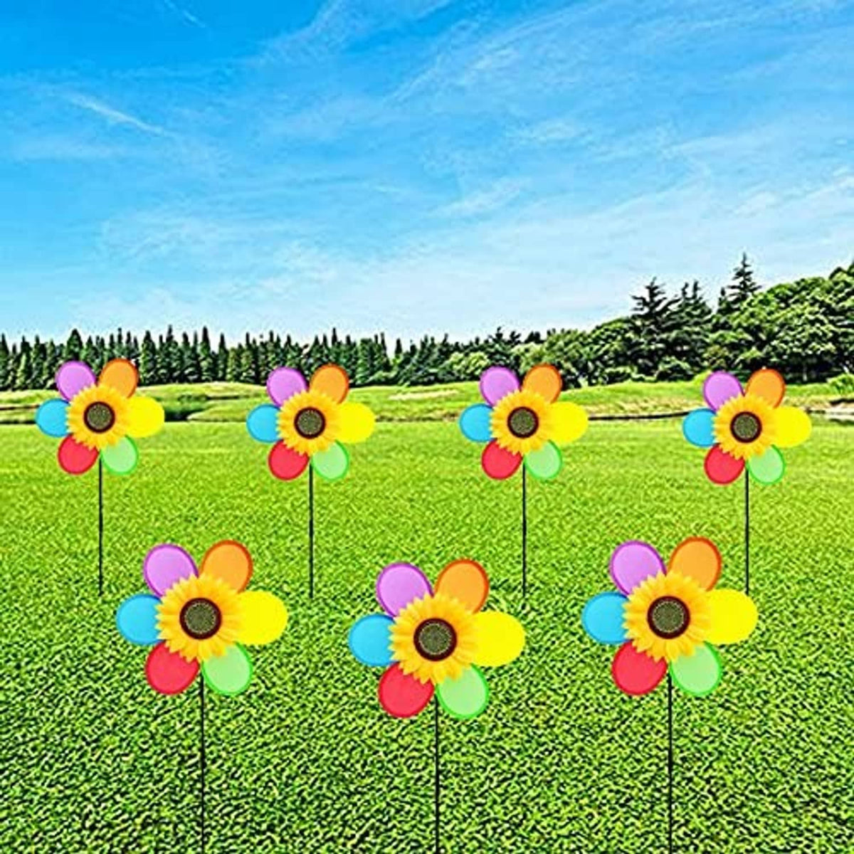 Multiple colorful sunflower pinwheel windmills on black stakes in a green yard