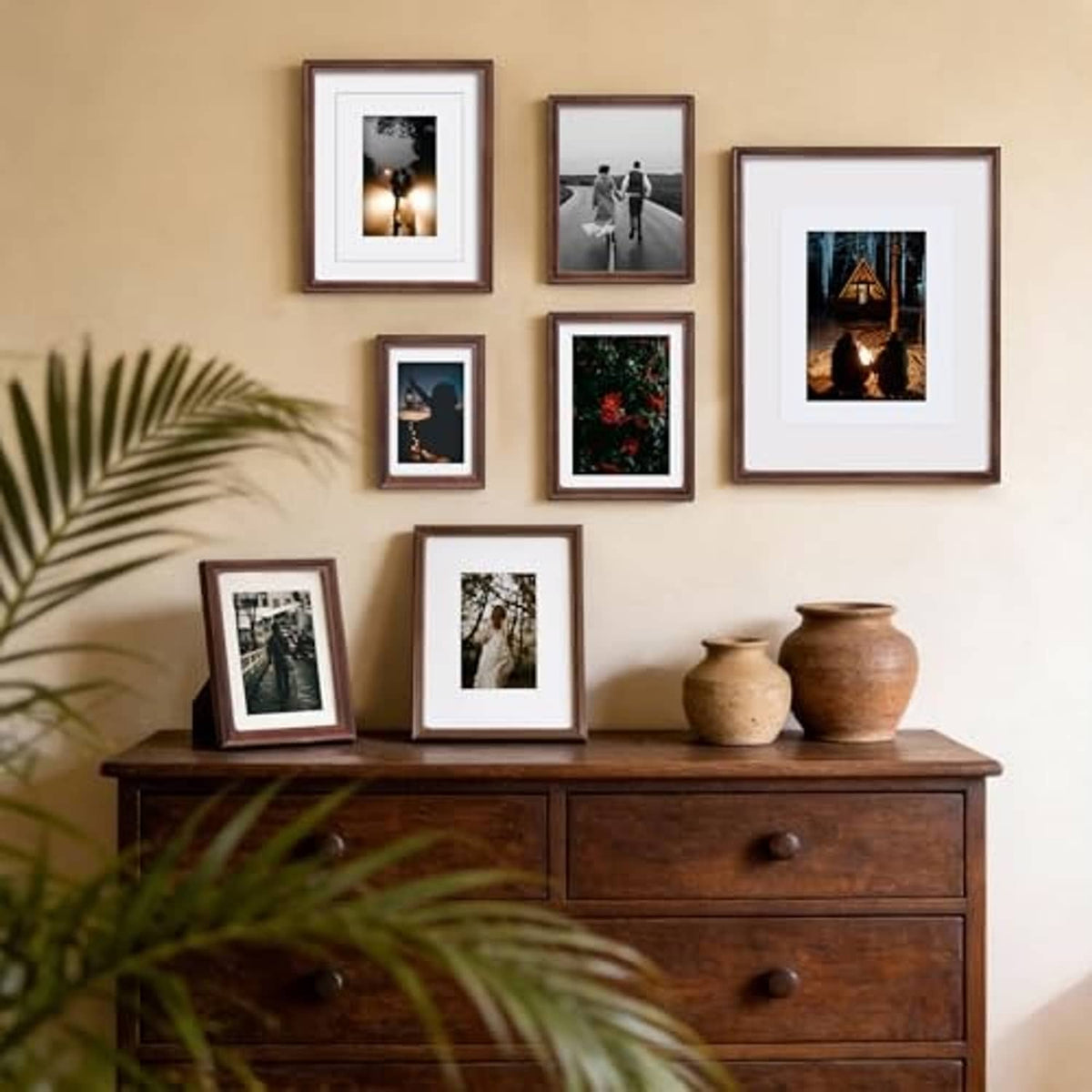 Wood 4x6 photo frames with white mats and clear glass arranged on wall display.