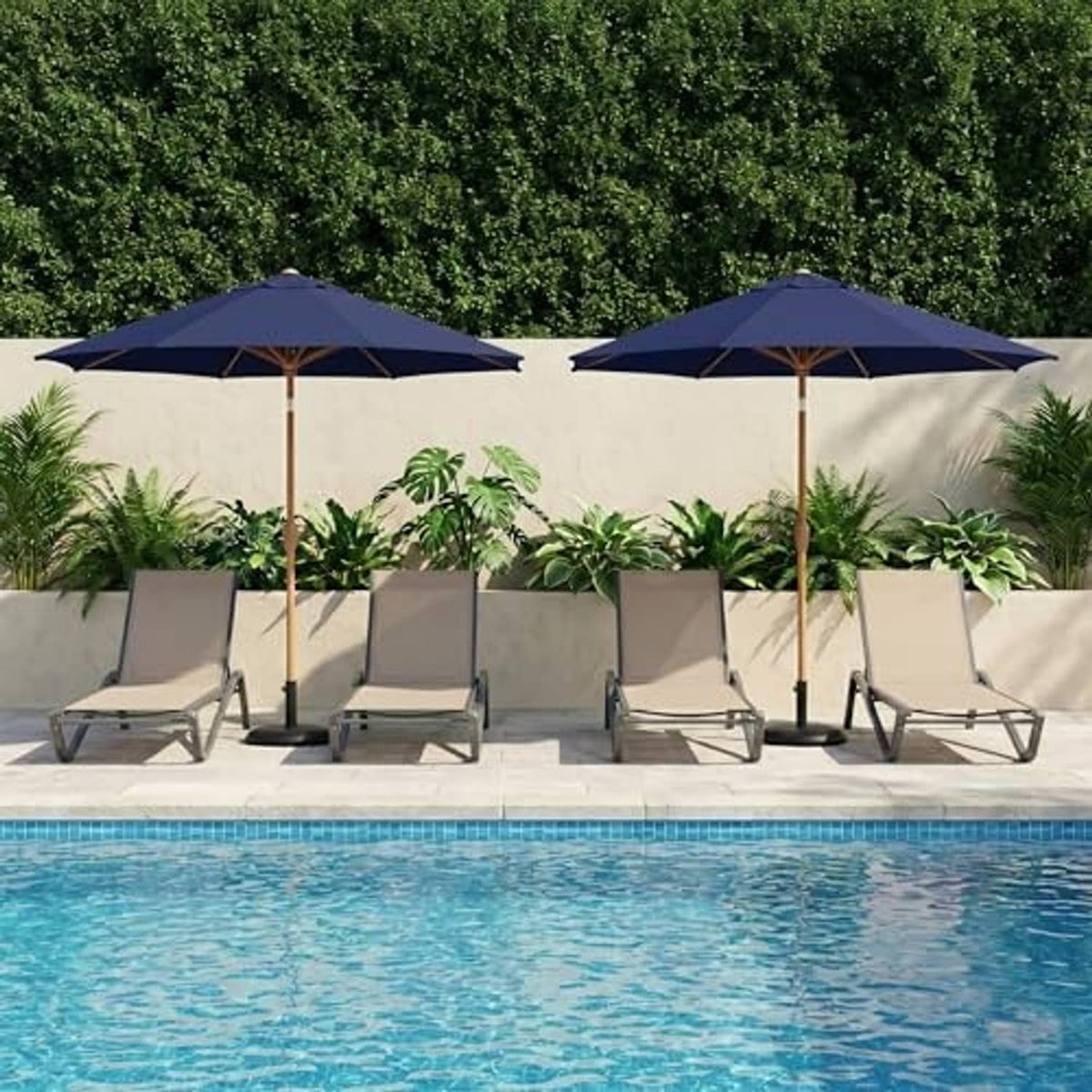 Two navy patio umbrellas over a poolside seating set with wooden poles
