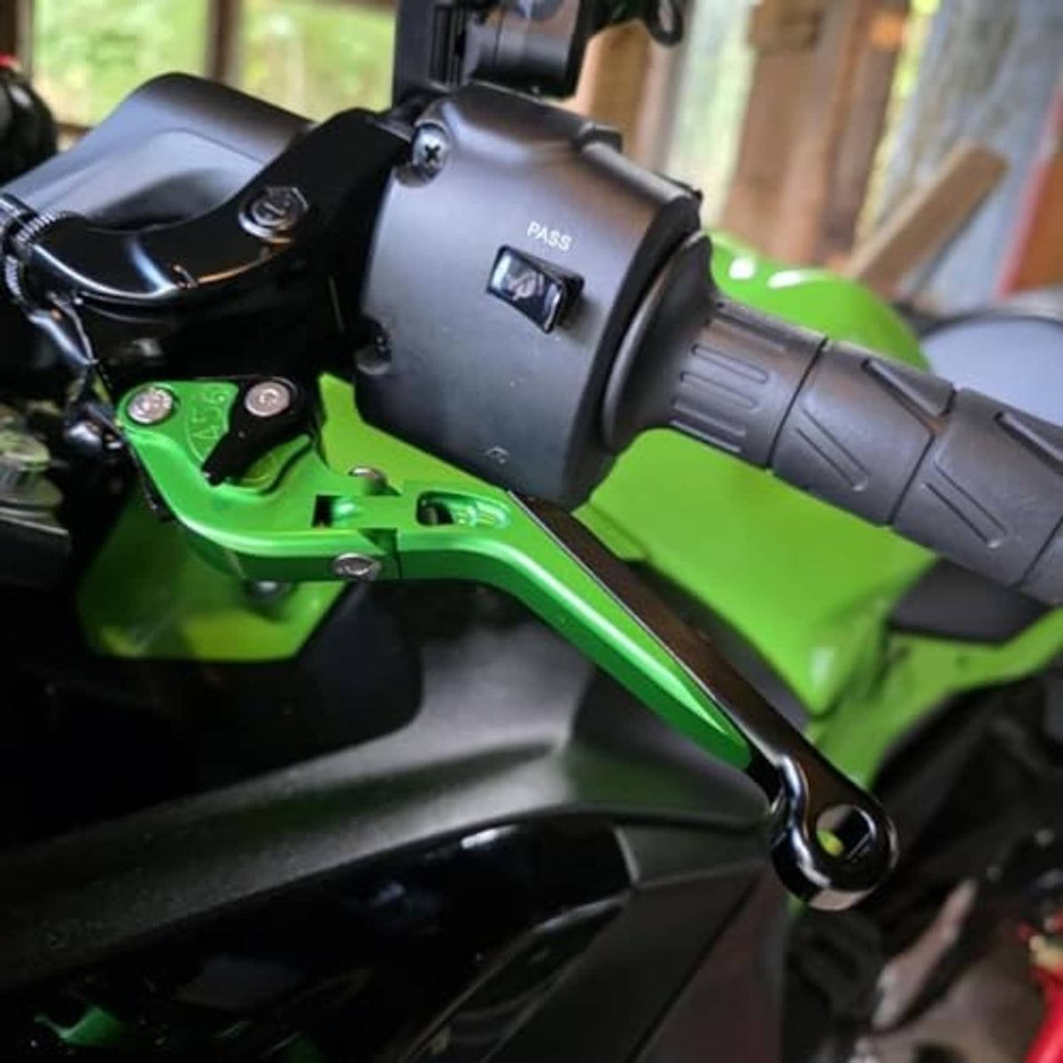 Brake clutch lever mounted on a motorcycle handlebar, black lever with adjuster