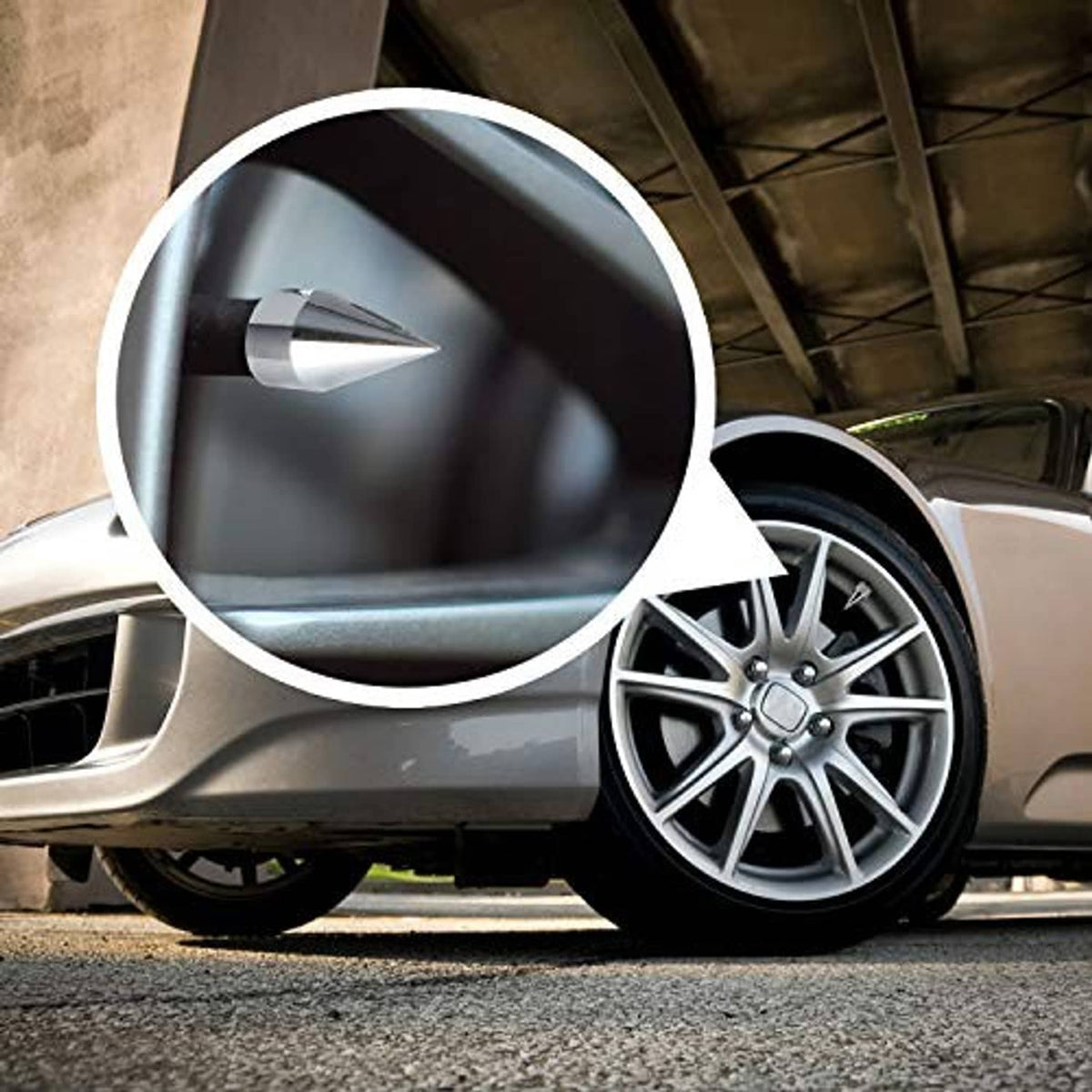 Silver chrome spiked valve cap installed on a car wheel rim