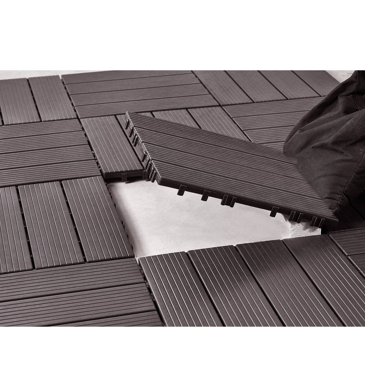 Interlocking deck tiles in dark gray, ribbed boards with raised locking tabs