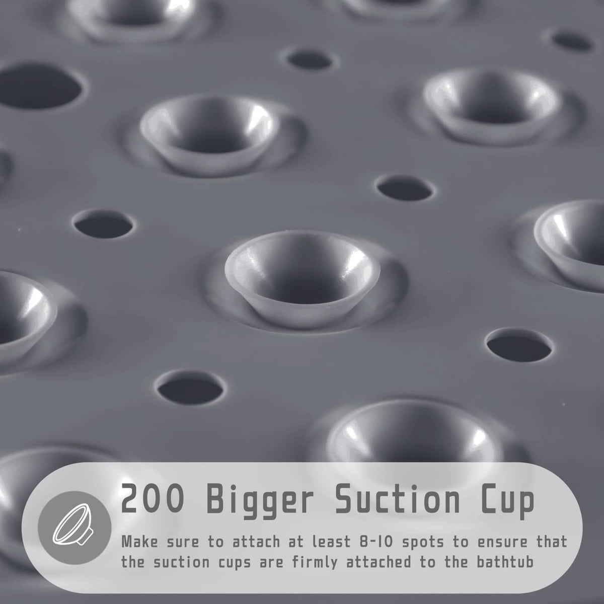Gray shower mat close-up with suction cup domes and drainage holes for tub grip