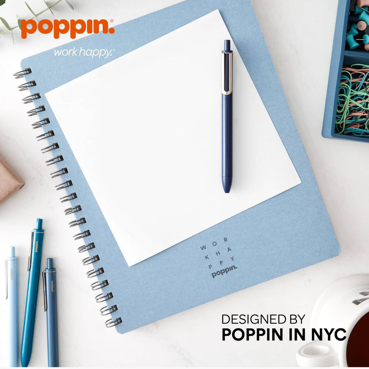 Blue retractable gel pen with gold clip, positioned on a notebook page