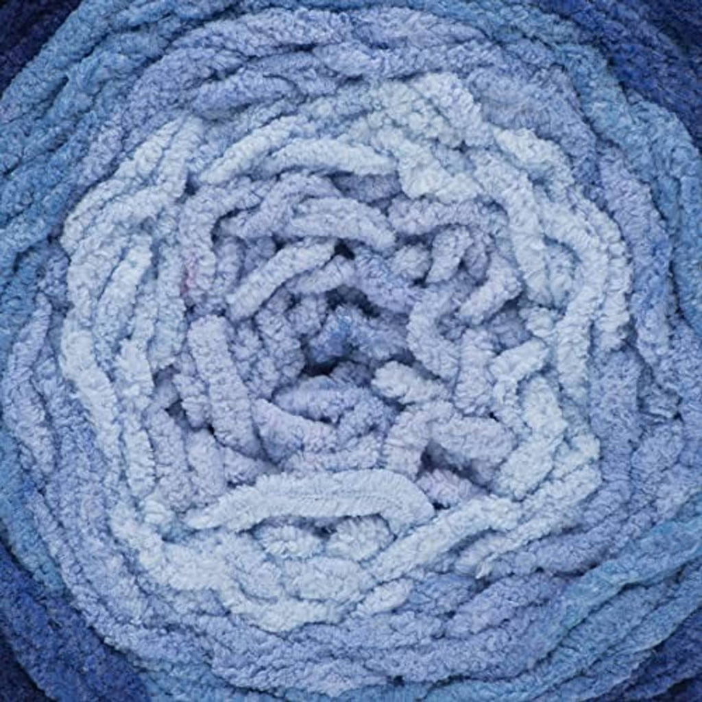 Light blue ombre yarn close-up with thick looped texture and spiral pattern