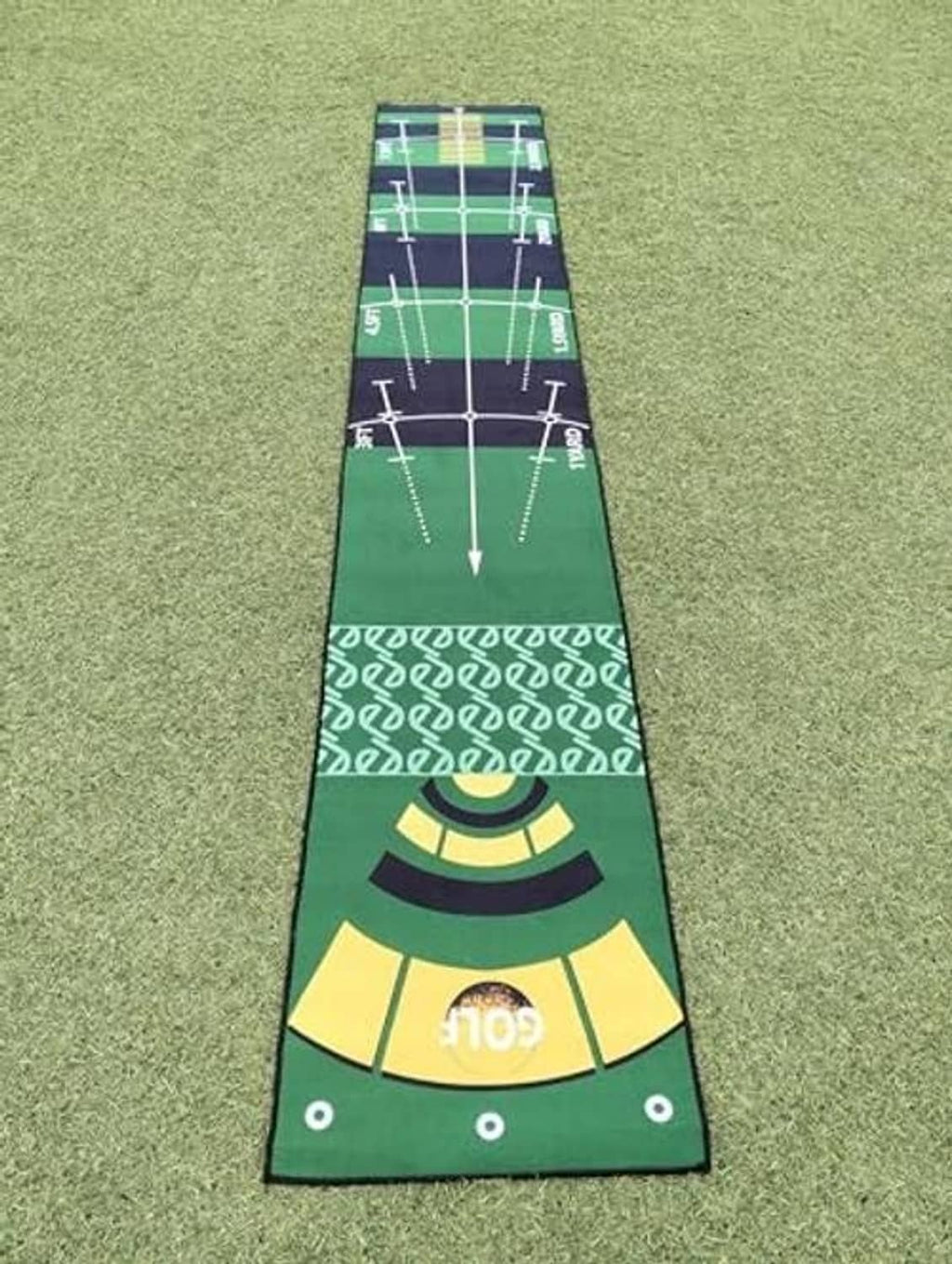 Close-up of green golf putting practice mat end with bullseye and guide dots