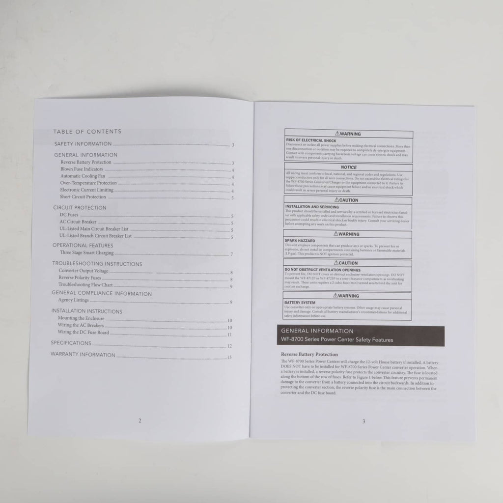 Open instruction manual pages with printed text and sections for setup and warnings