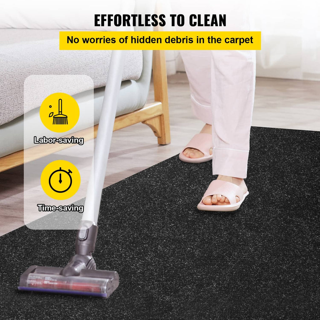 Dark charcoal marine carpet on the floor with a vacuum cleaning the surface