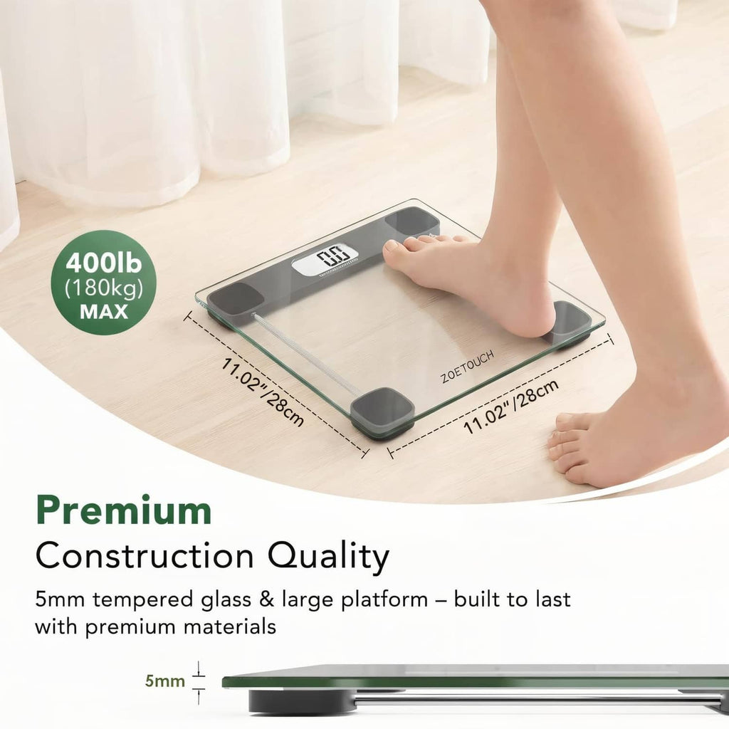 Flat tempered-glass bathroom scale with dark pads and LCD weight readout