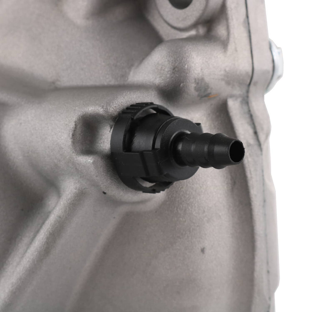 Close-up of front differential carrier assembly outlet connection, black cap on silver housing