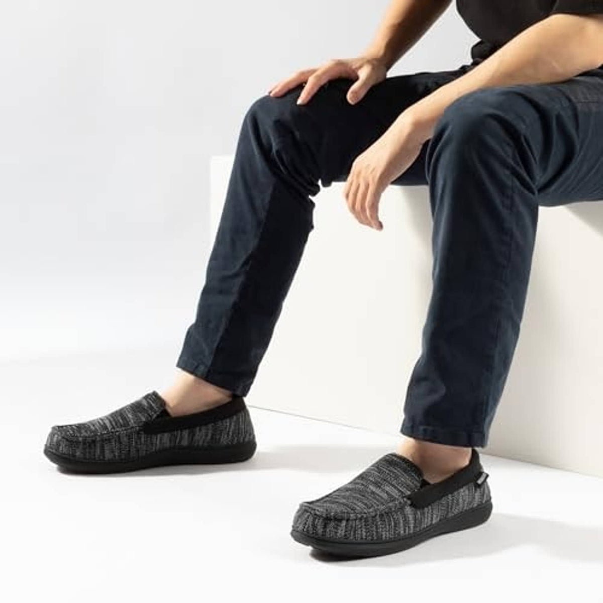 Men's tweed moc slippers on feet, charcoal-black knit upper, slip-on comfort