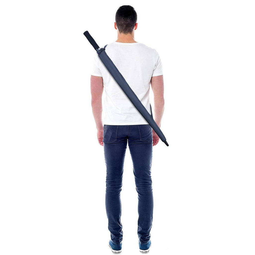 Navy blue golf umbrella held by a person with straight strap handle