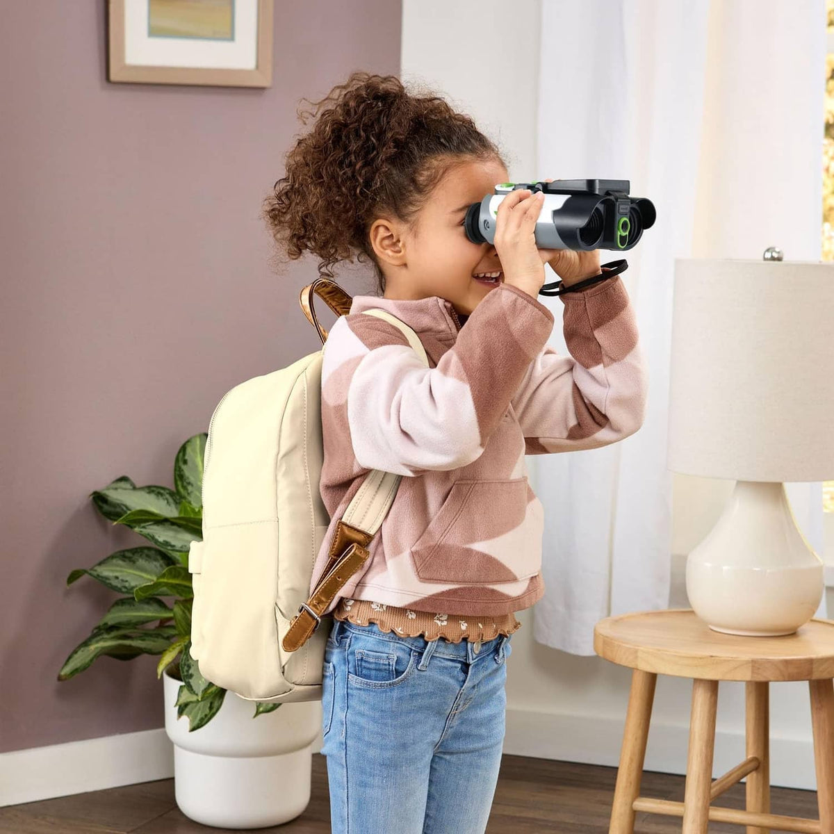 Child looking through binoculars with built-in color screen display