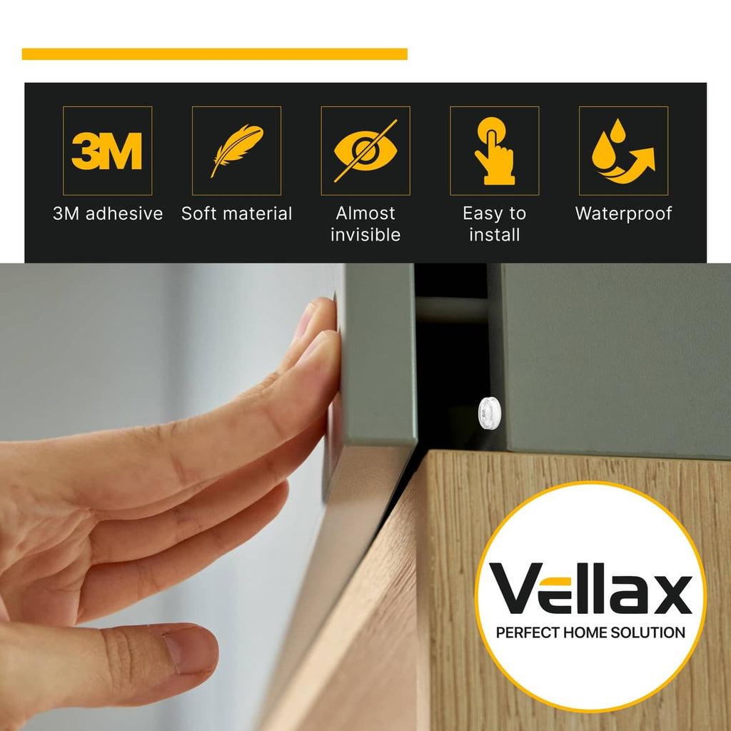 Hand applying clear self-adhesive silicone bumper to cabinet door edge