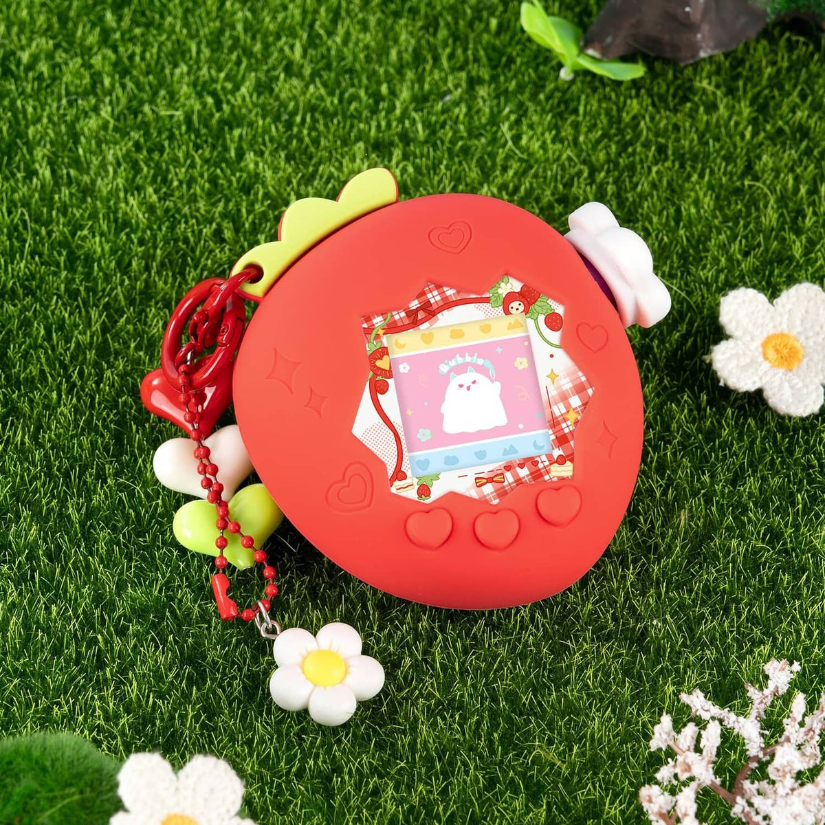 Red bubble protective case on grass with bear-ear top, bead chain, and flower charms