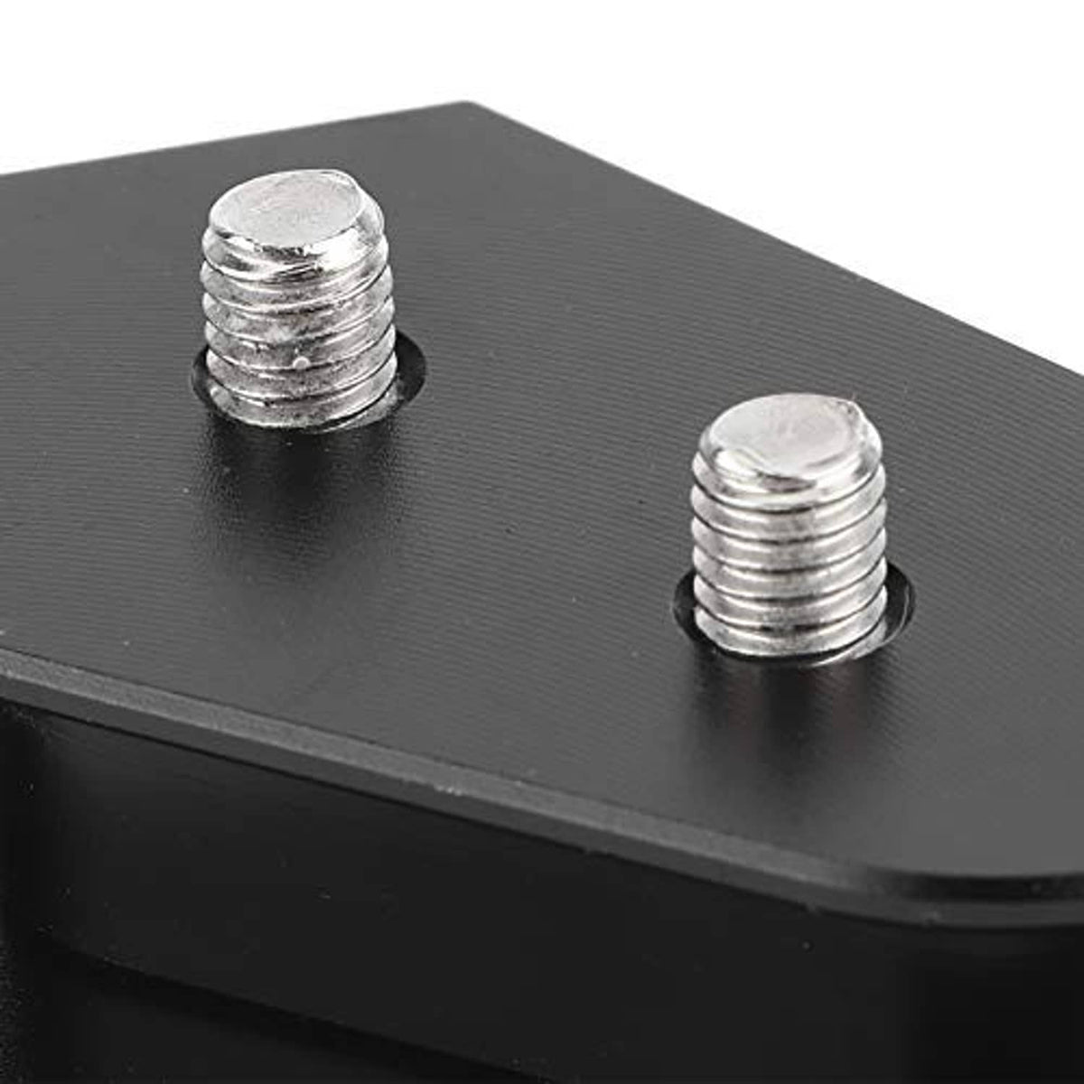 Close-up of black brake pedal extension pad showing two chrome threaded mounting studs