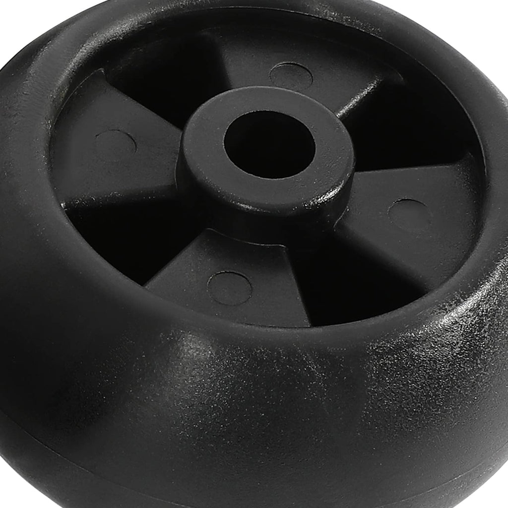 Close-up of a black plastic wheel hub with center axle hole and molded spokes