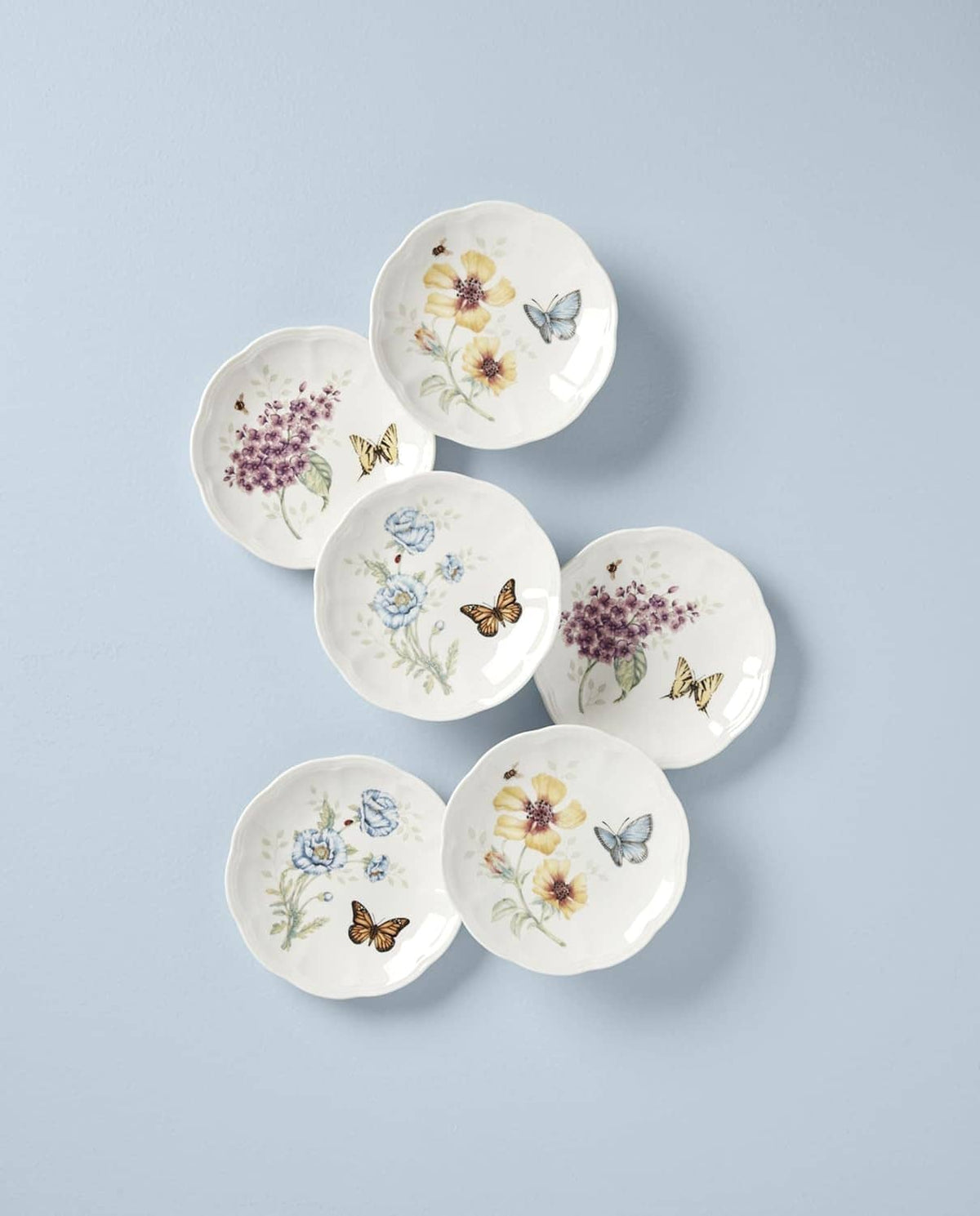 Set of six small round decorative plates with butterflies and flowers, white porcelain