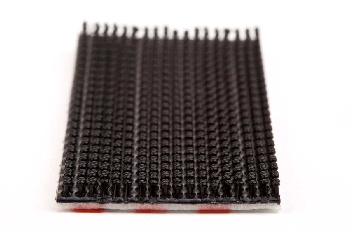 Close-up of black interlocking fastener strip with dense hook texture