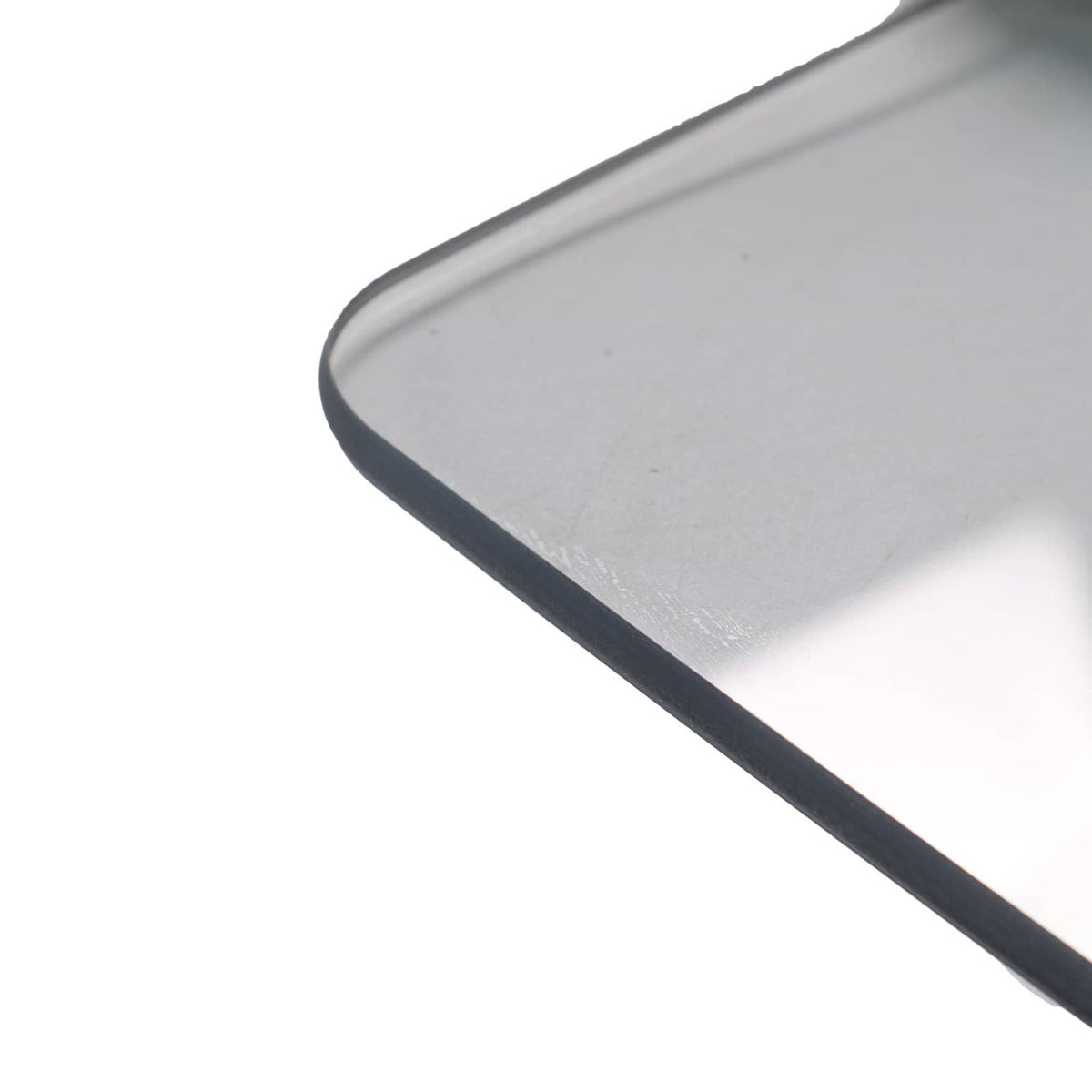 Front windshield panel corner with dark trim along rounded edge, clear tinted plastic.