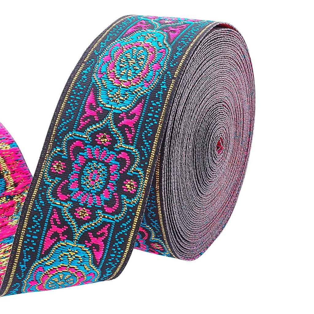 Embroidered jacquard ribbon roll with dark base, teal and magenta floral medallions