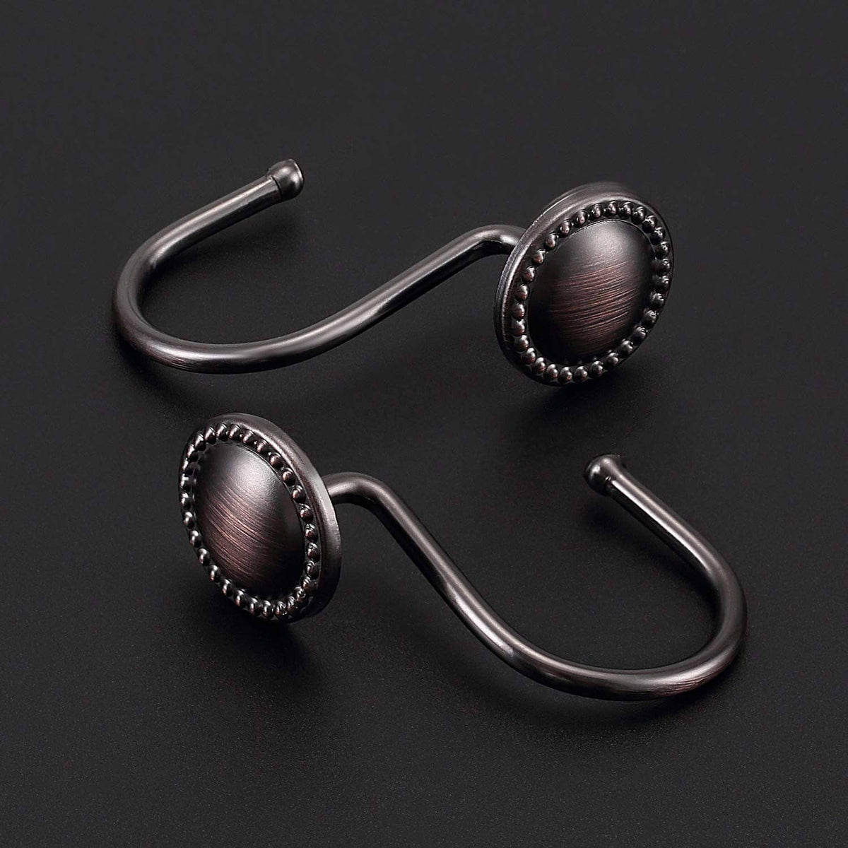 Oil-rubbed bronze shower curtain hooks with oval beaded rosettes and curved bars