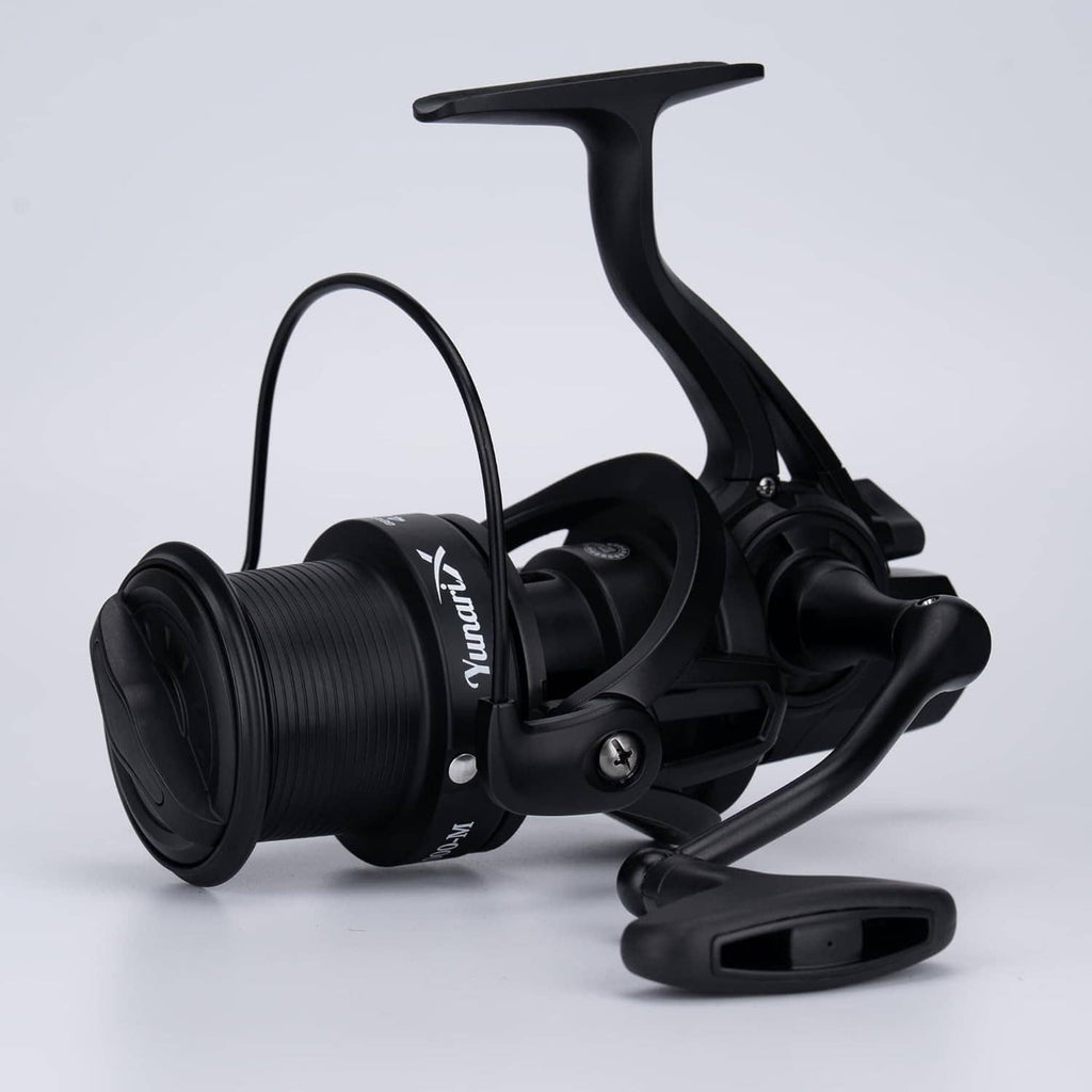Black spinning fishing reel with arched bail, line guide, and ribbed spool, side view