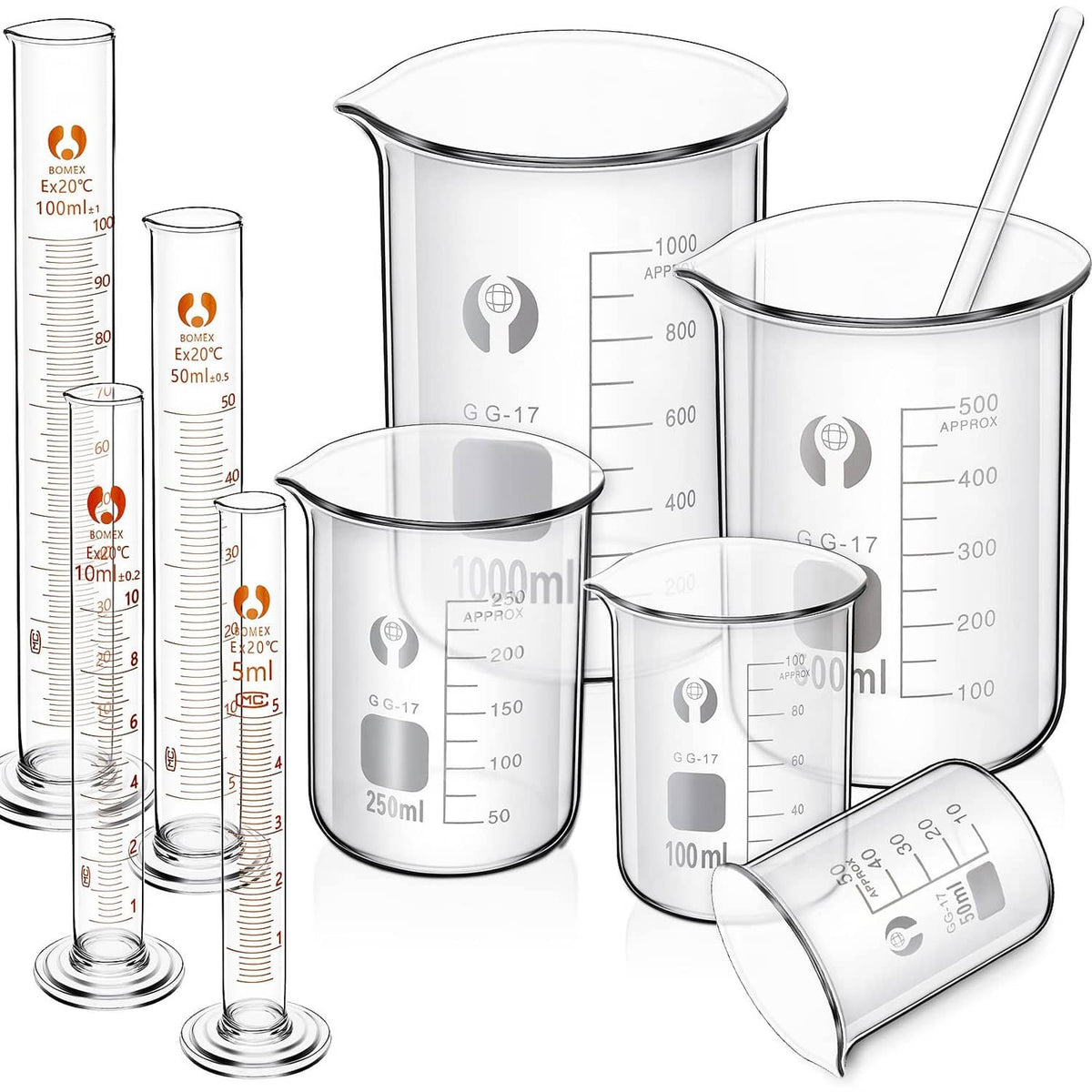 Set of clear glass measuring beakers and graduated cylinders with spouts and handles