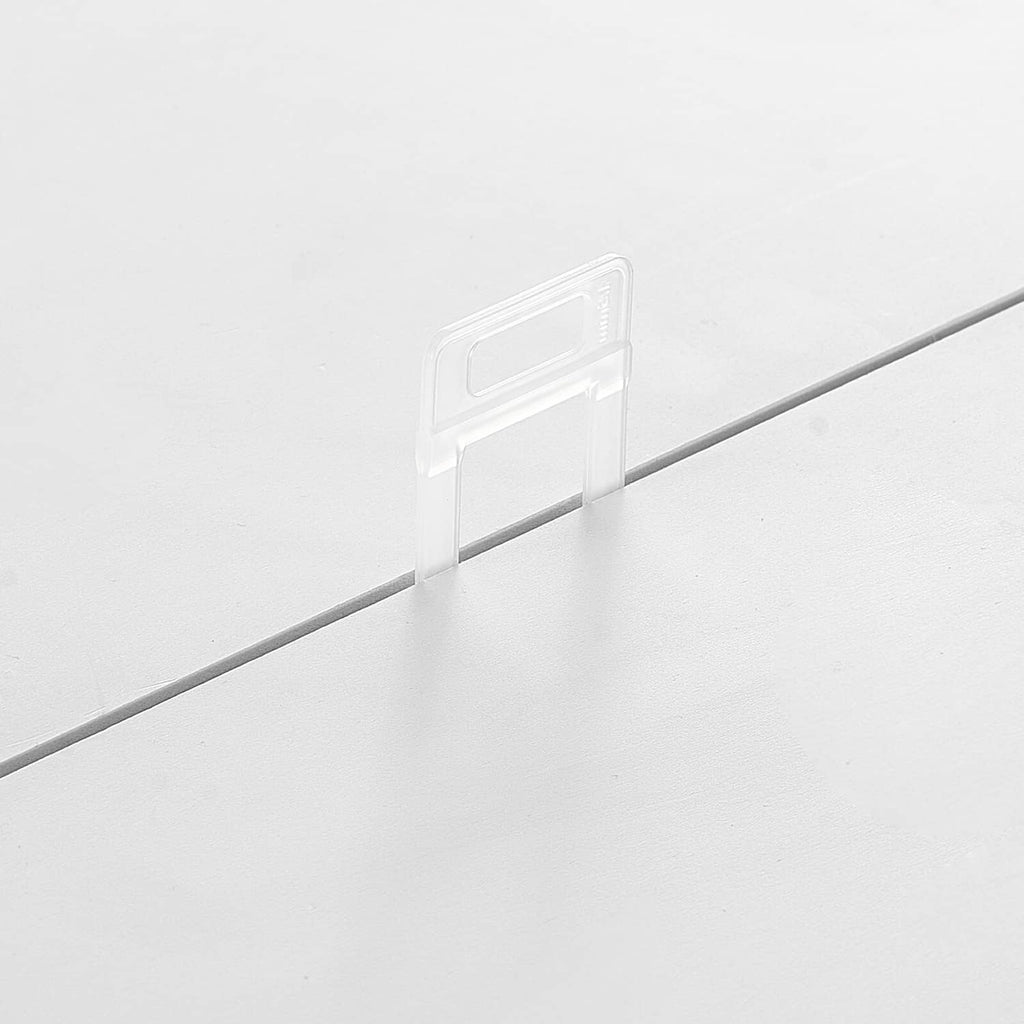 Clear tile leveling spacer clip installed at a tile joint for straight, even alignment