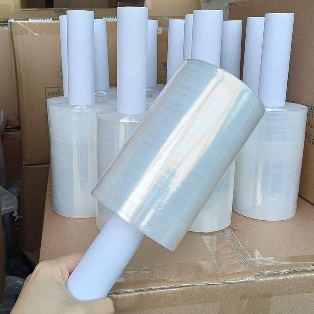 Clear stretch wrap rolls stacked, with one roll held in the foreground