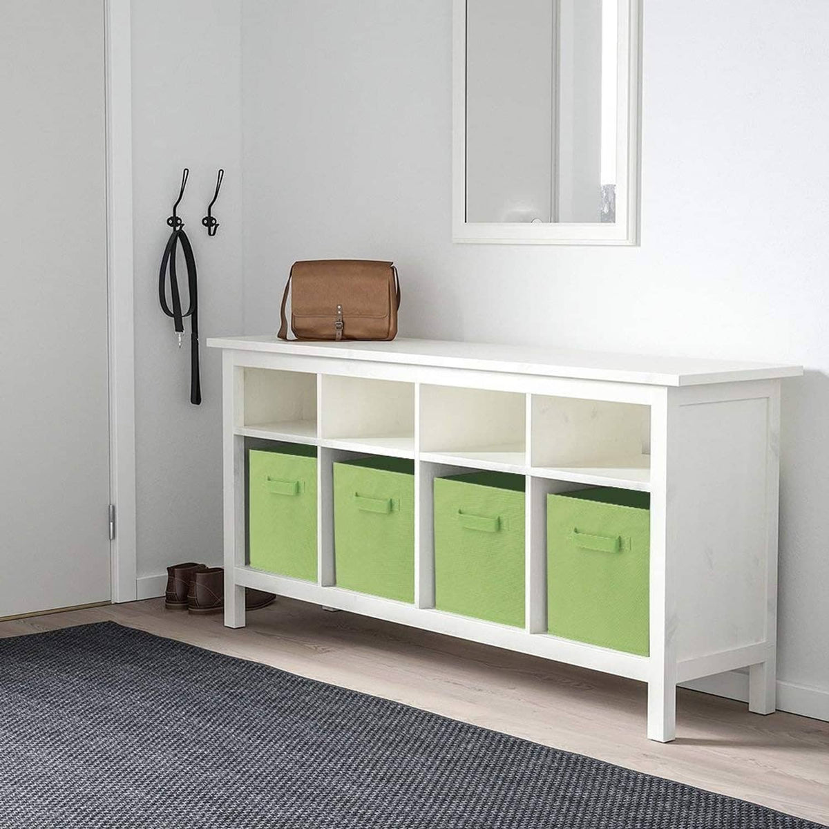 Green fabric storage cube with two front pull handles in a bench organizer