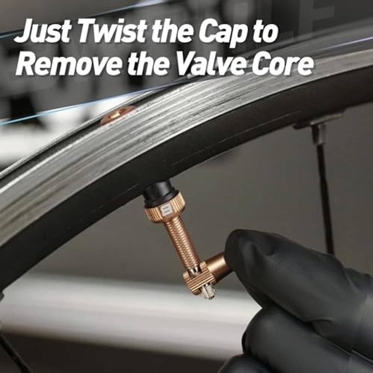 Brown tubeless Presta valve stem with black base, shown near the rim opening