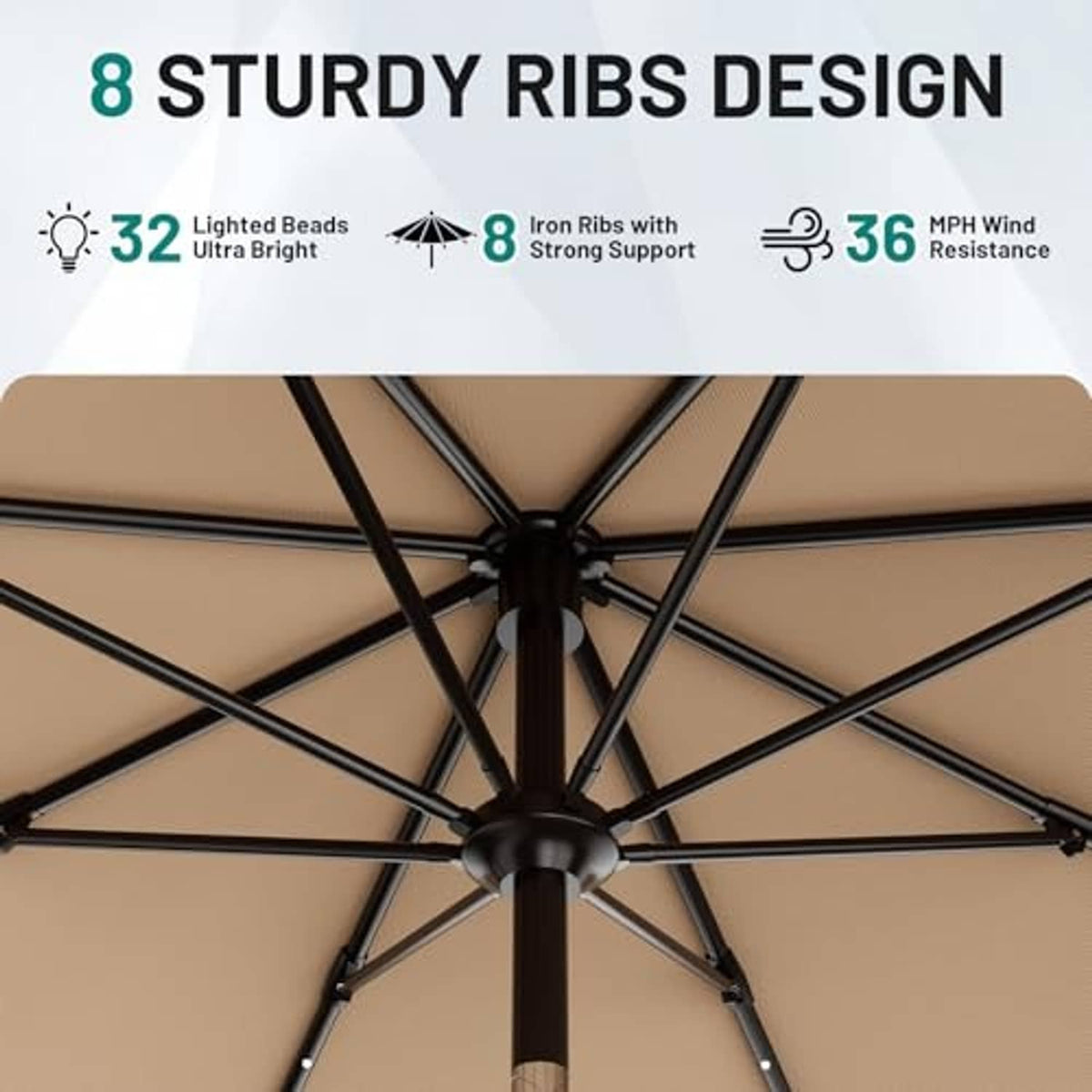 Underside of beige patio umbrella with black ribs and lighted beads