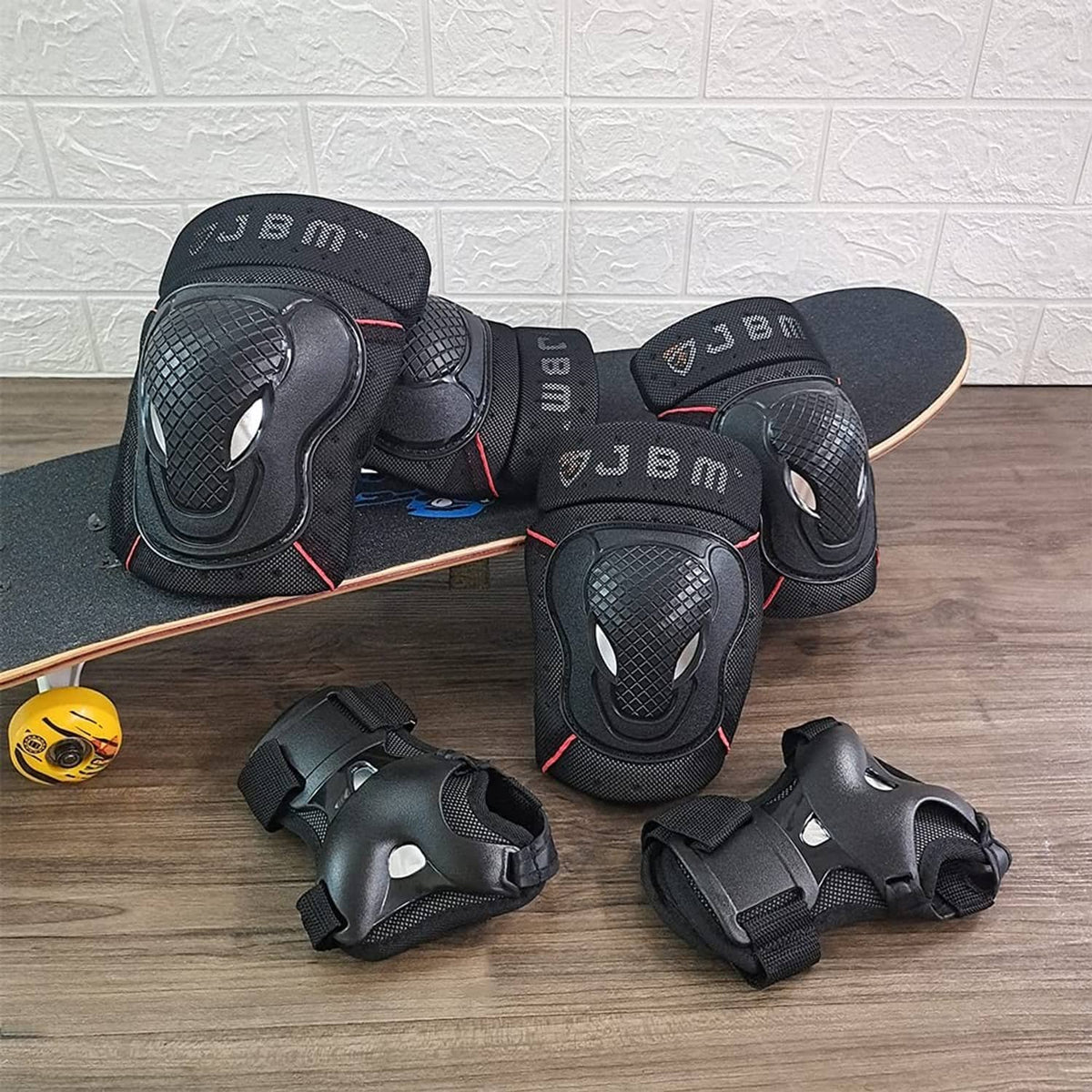 Black bike protective pads set: knee, elbow, and wrist guards laid out with straps.