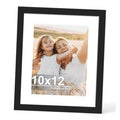 Black 10x12 picture frame with glass and white mat, holding photo of two children