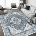 Blue-gray ornate rectangular area rug with central floral medallion pattern