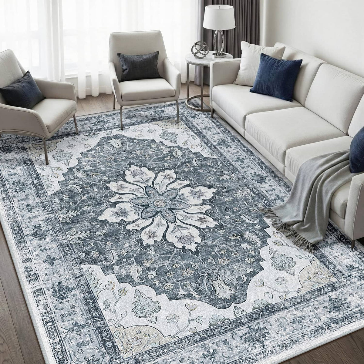 Blue-gray ornate rectangular area rug with central floral medallion pattern