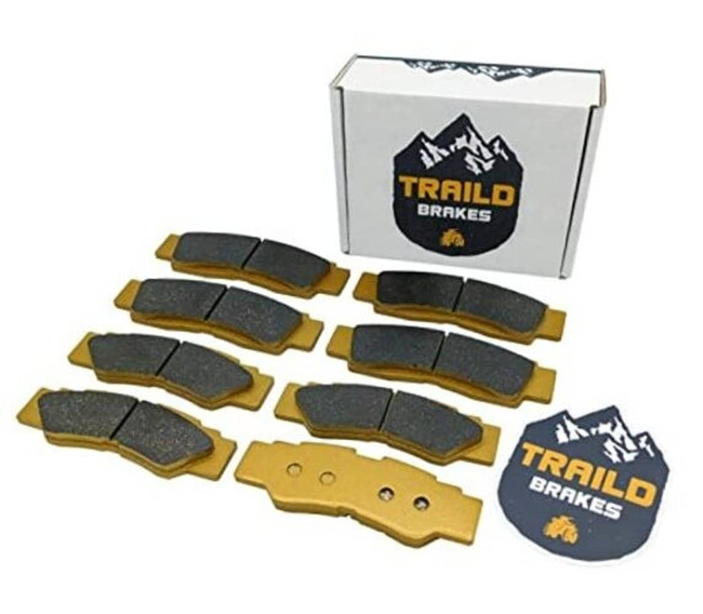 Ceramic brake pad set with mixed dark friction pads and gold backing plates