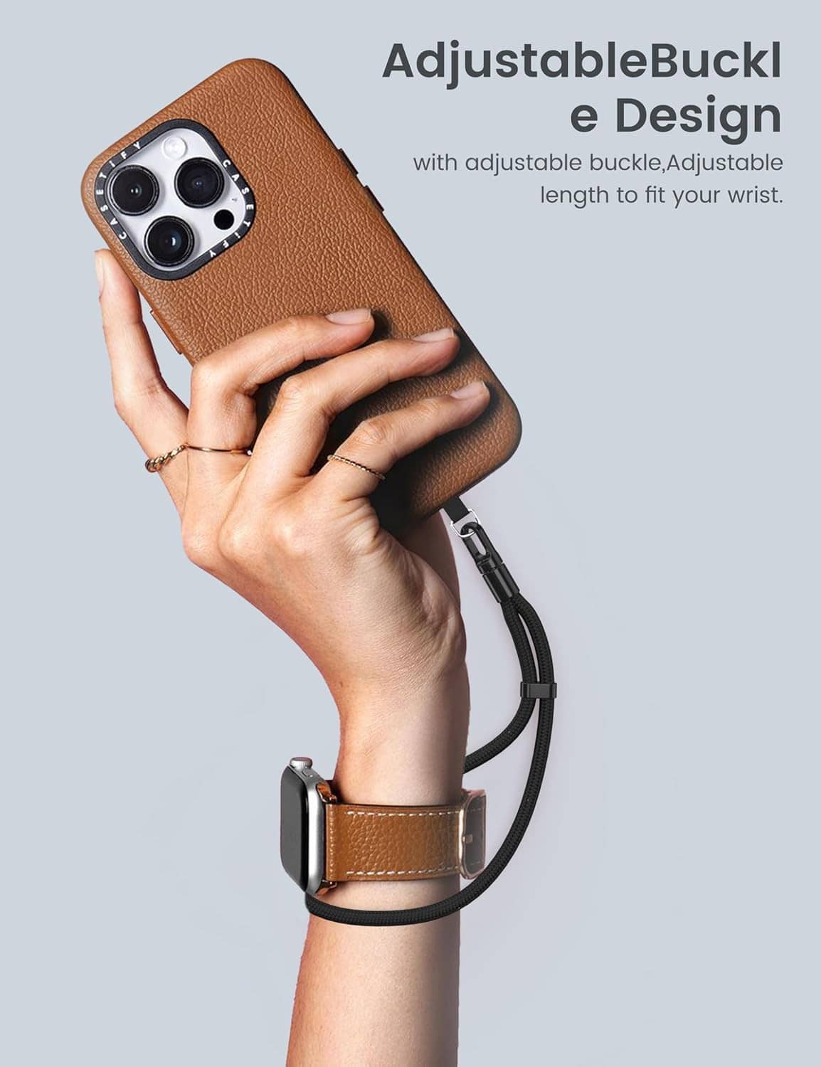 Phone lanyard with adjustable loop holding a phone and wrist strap, dark gray/black