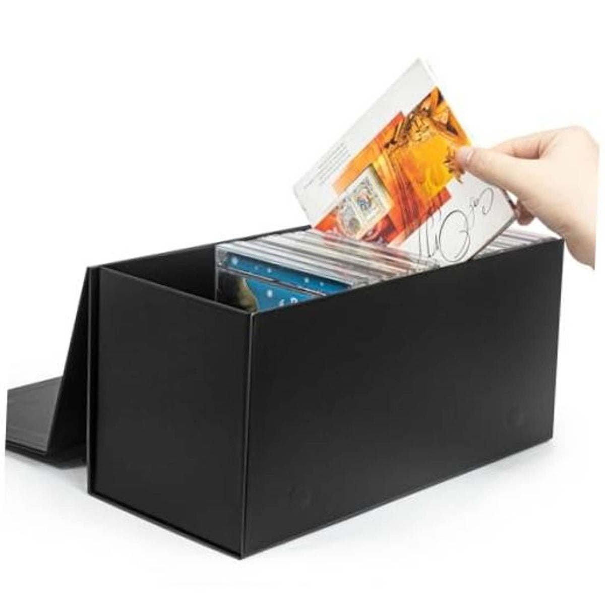 Black CD/DVD storage box with open top, holding stacked CD cases and a booklet