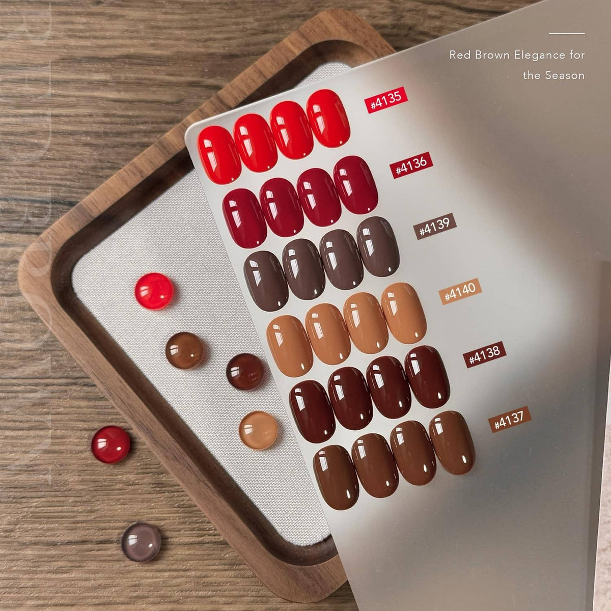 Gel nail polish color card with red and brown swatches and small bottle dots