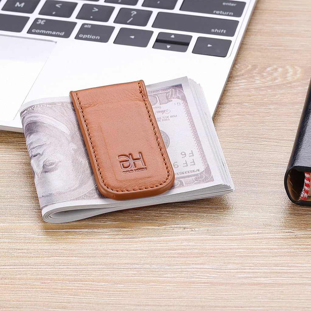 Brown leather money clip with DH logo holding a stack of bills