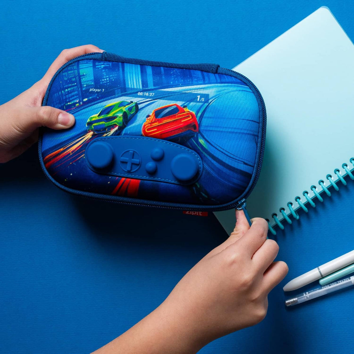 Blue zipper pencil case close-up with game-controller buttons graphic on the front.