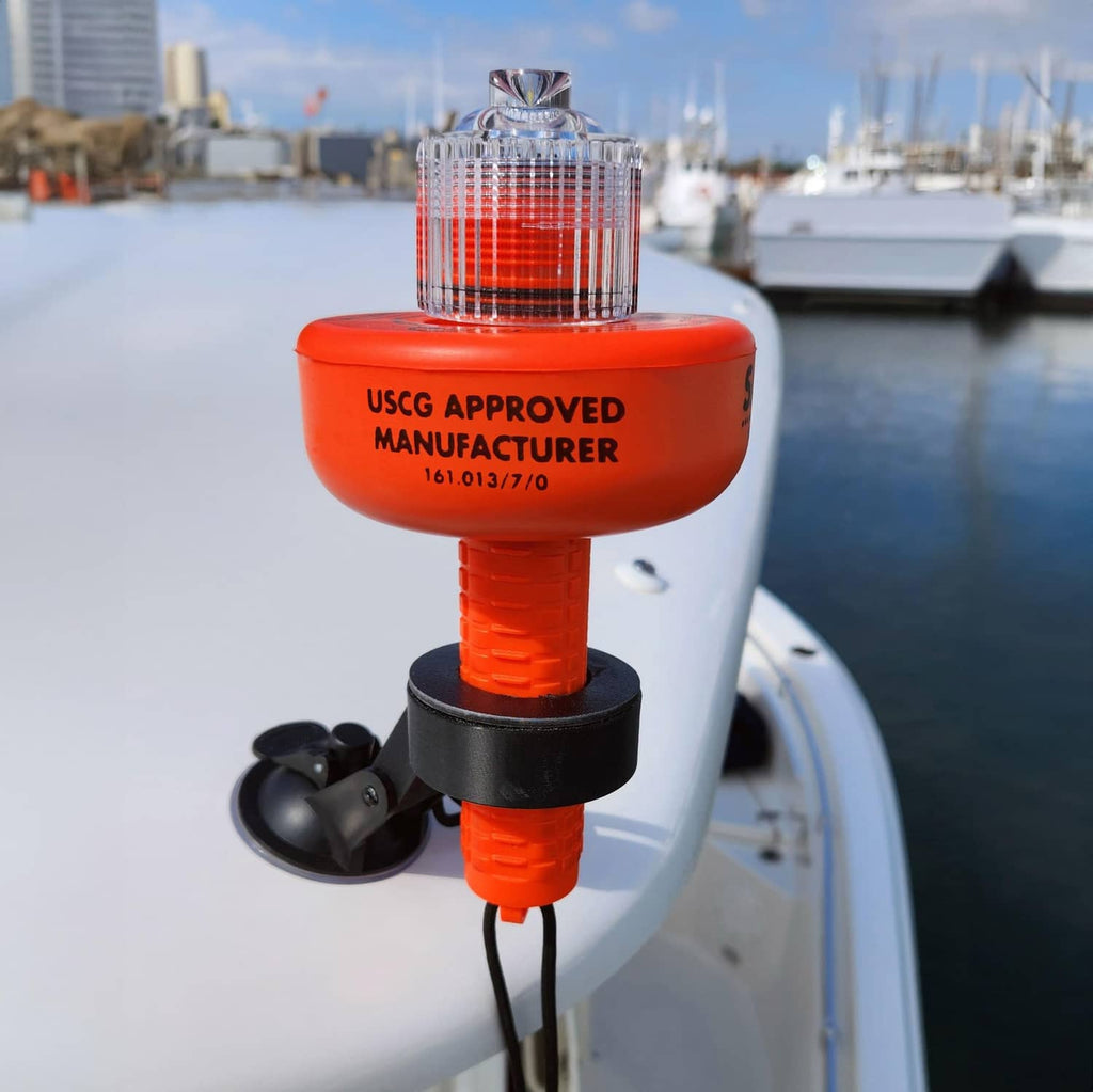 Red USCG-approved SOS LED distress flare mounted on a boat with clear lens