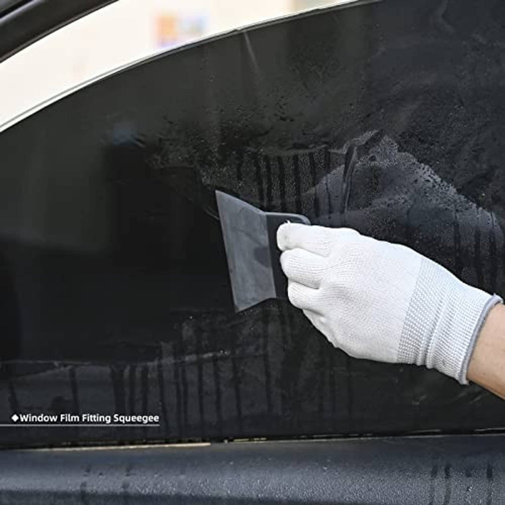 Black window film squeegee with frosted edge, held by gloved hand