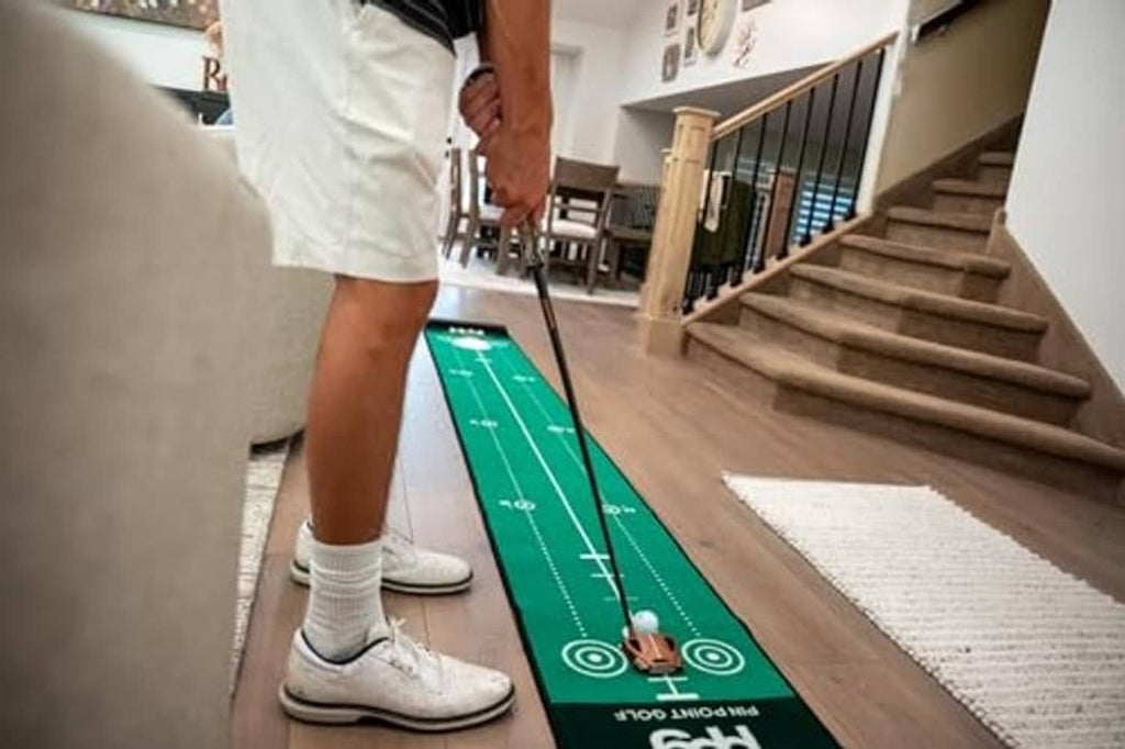 Green putting mat with distance lines and a player standing over it